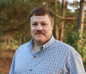 Image of Colby Lambert in a wooded area.