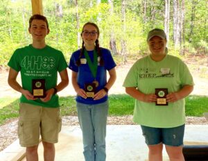  Three 4-H youth, one male two female, holding their award plaques
