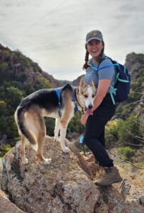 Image of Sarah Cain hiking with her dog.