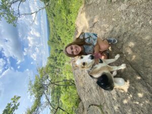 Image of Sarah Cain hiking with her dog.